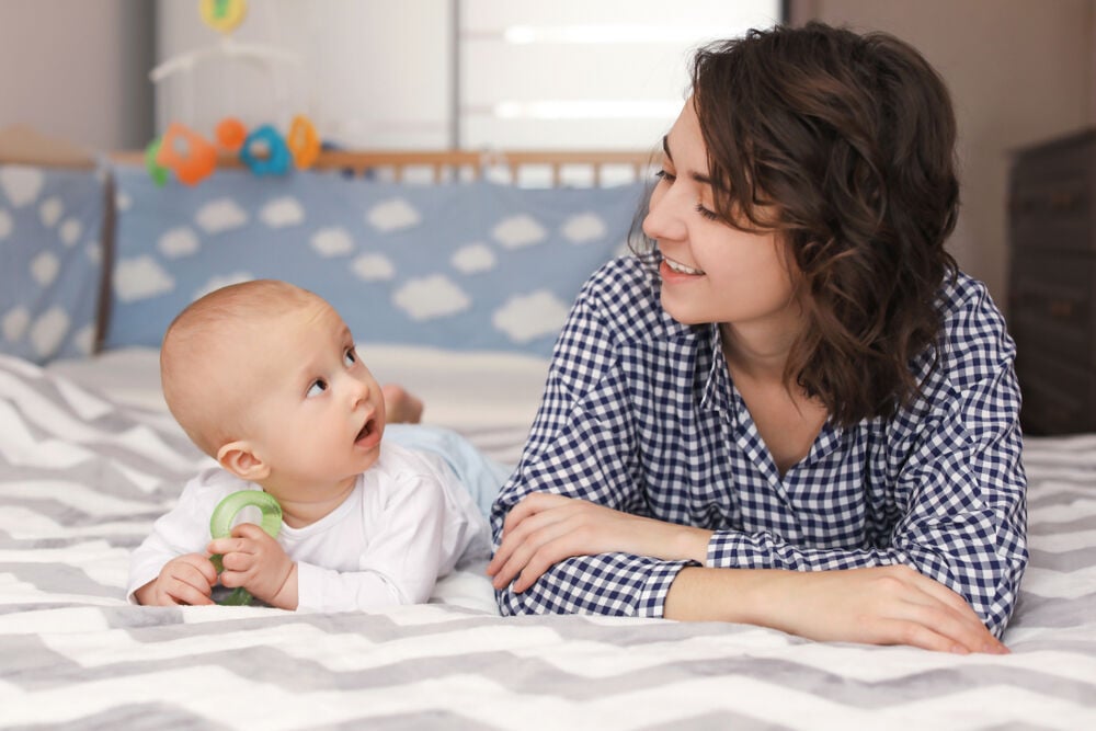 A baby holding a baby teether A baby holding a baby teether