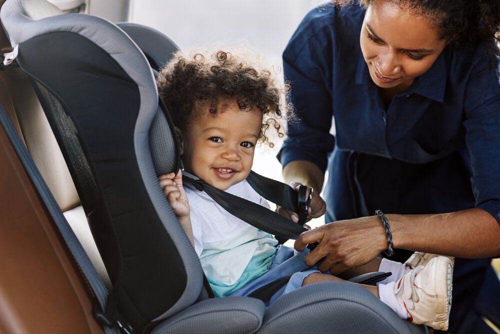 A mother thinking when to change car seats A mother thinking when to change car seats