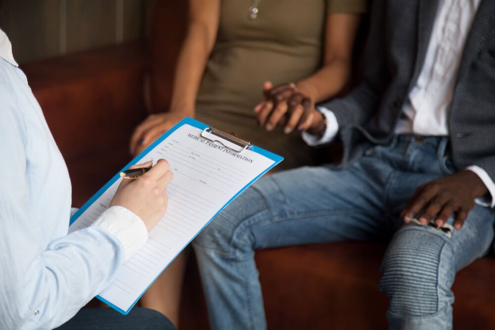 A couple getting advice from a doctor on how to get pregnant with blocked fallopian tubes A couple getting advice from a doctor on how to get pregnant with blocked fallopian tubes