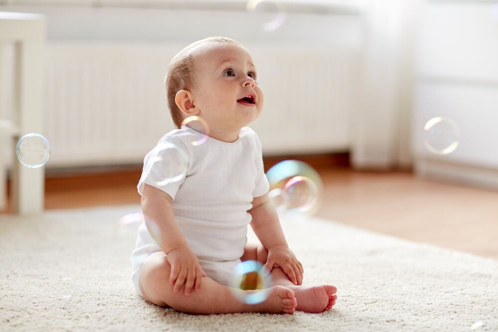 A 6-month-old baby playing with bubbles A 6-month-old baby playing with bubbles