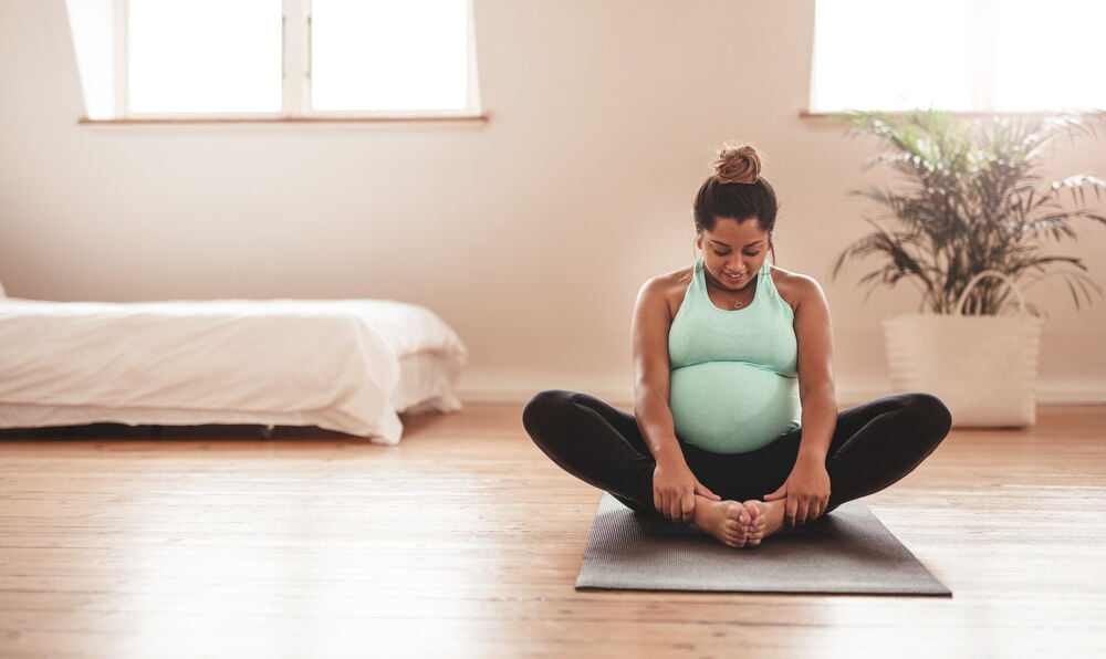A woman doing prenatal yoga poses in the third trimester  A woman doing prenatal yoga poses in the third trimester