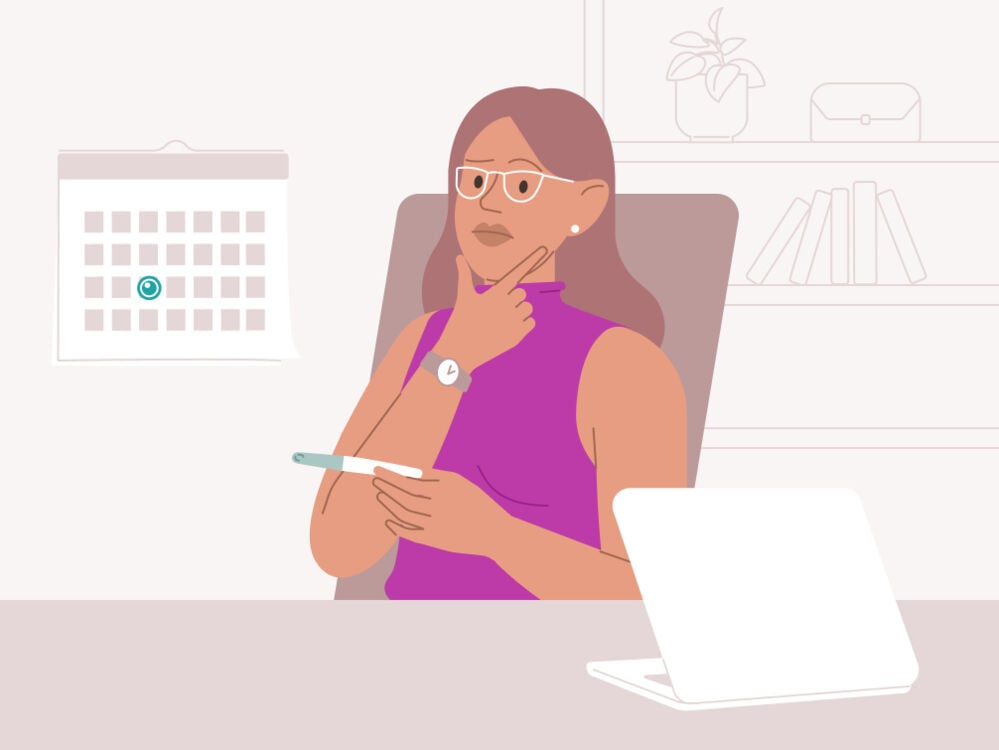 woman holding a pregnancy test and reading the instructions woman reading the instructions for a pregnancy test