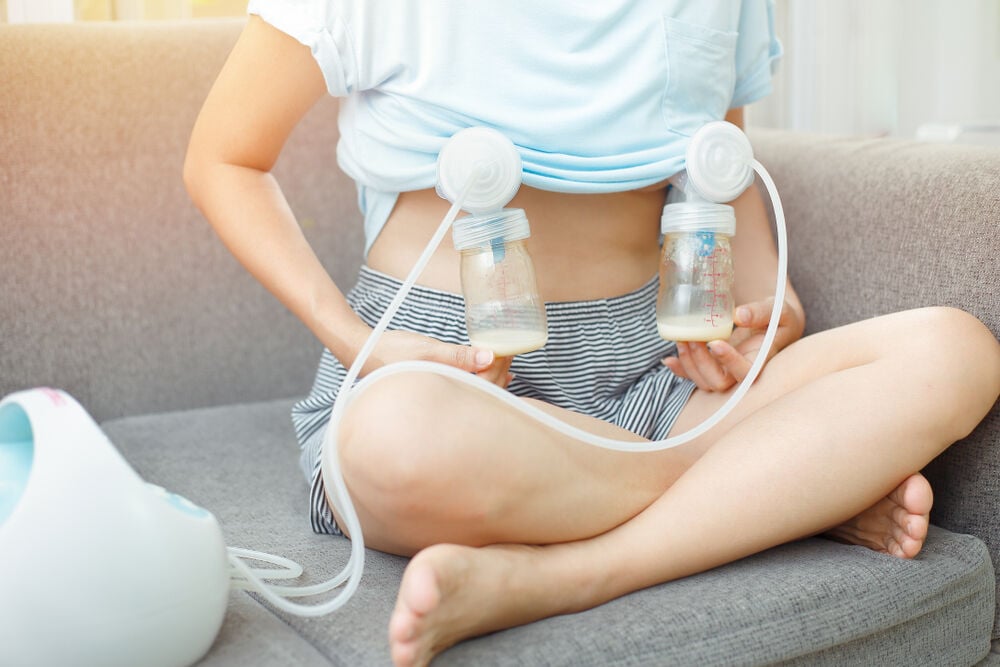 Mom using electric breast pump to store breast milk Mom using electric breast pump to store breast milk