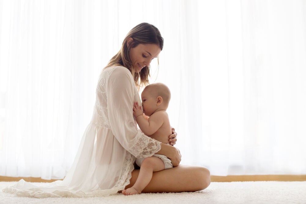 A woman breastfeeding her baby to keep her breasts big after pregnancy A woman breastfeeding her baby to keep her breasts big after pregnancy