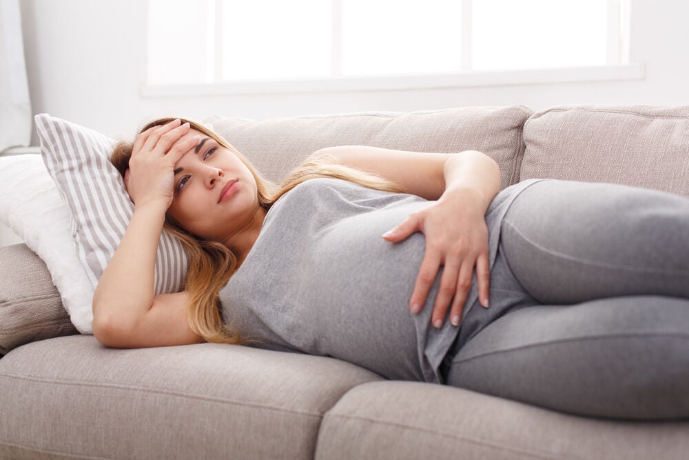 A woman suffering from stomach pain during pregnancy A woman suffering from stomach pain during pregnancy