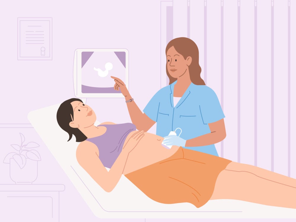 woman looking at her baby on the screen at an ultrasound scan woman at an ultrasound scan
