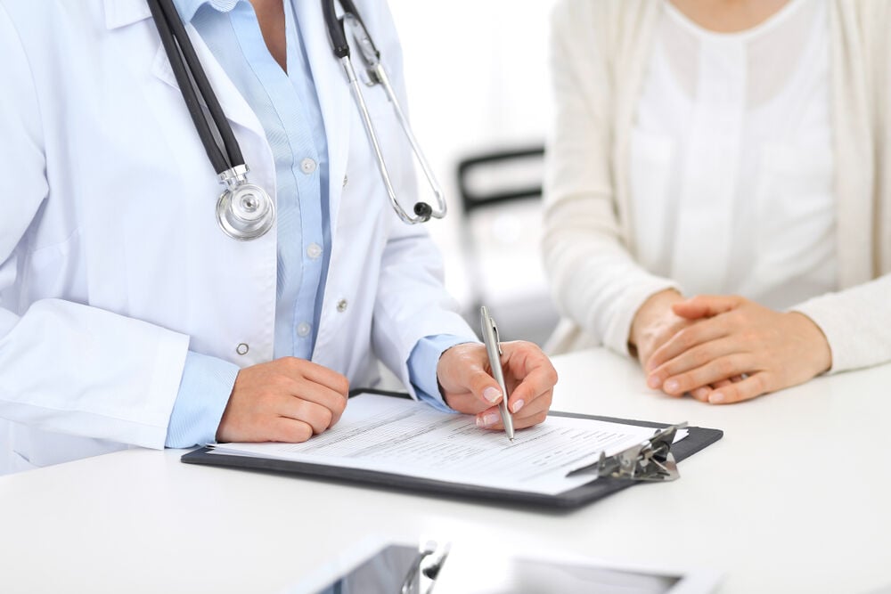 doctor and female patient discussing swollen lymph nodes doctor and female patient discussing swollen lymph nodes