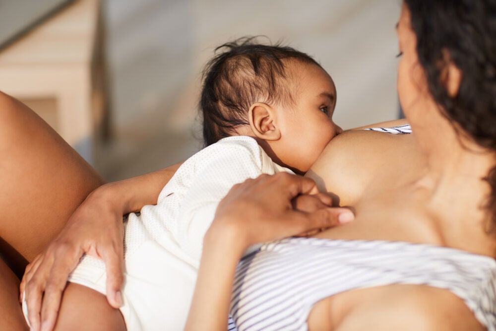A woman breastfeeds a baby with ankyloglossia A woman breastfeeds a baby with ankyloglossia