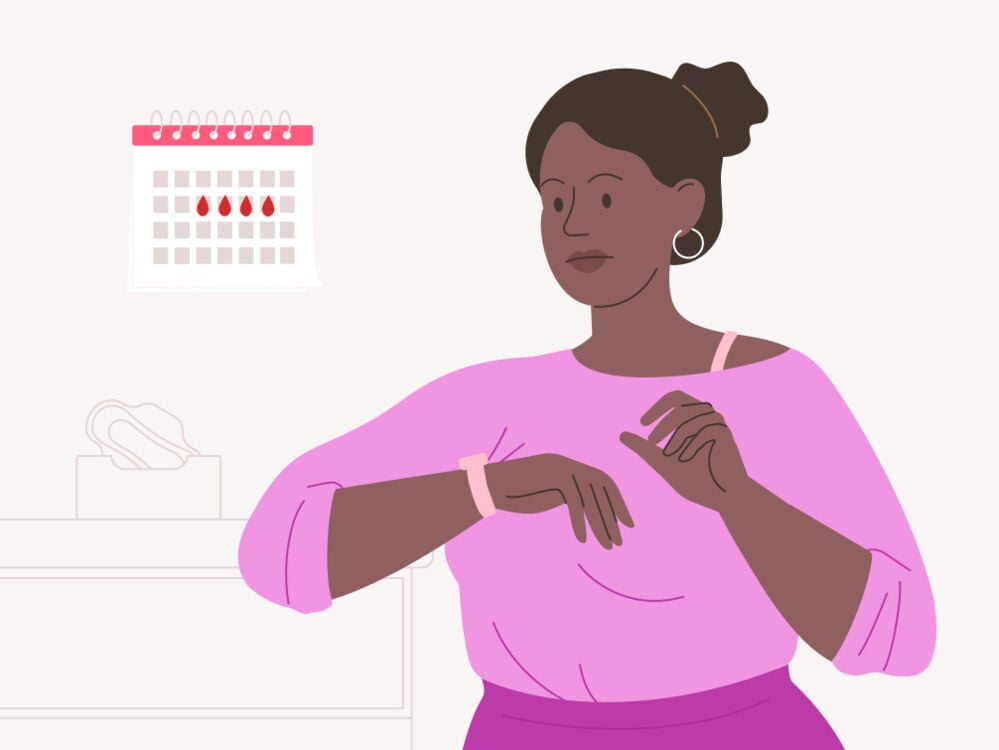 woman looking at her period marked out on a calendar woman looking at her period on a calendar