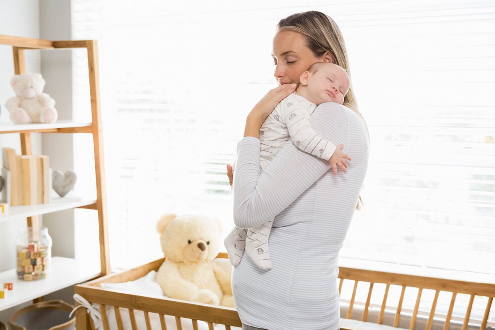 A mother holding her baby in a proper way A mother holding her baby in a proper way