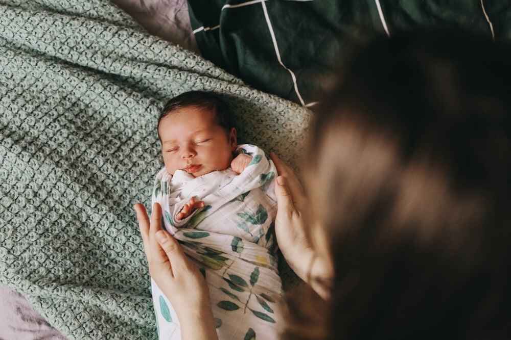 A mother swaddling a baby A mother swaddling a baby
