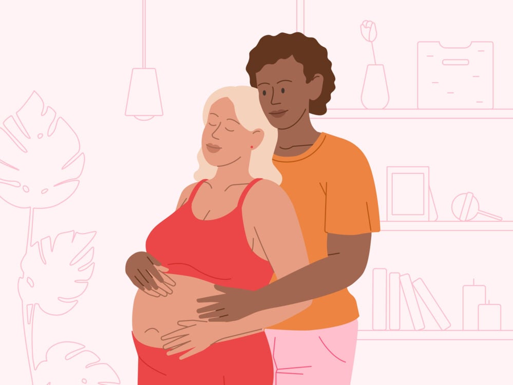 A couple hugging and holding a pregnant belly pregnant woman hugging her partner