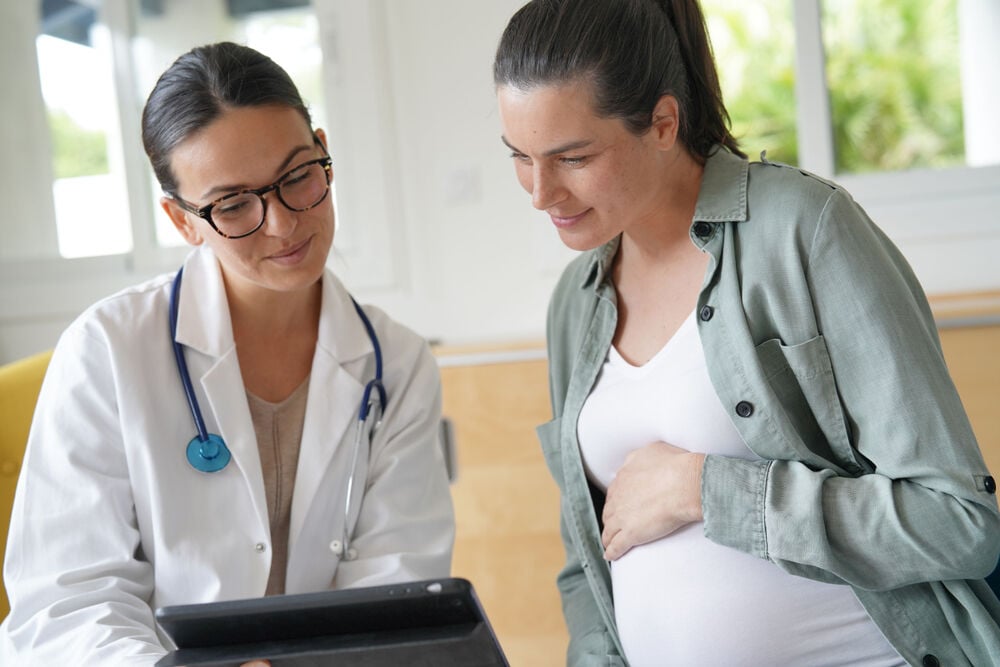 A woman looking at the results of a gender blood test A woman looking at the results of a gender blood test
