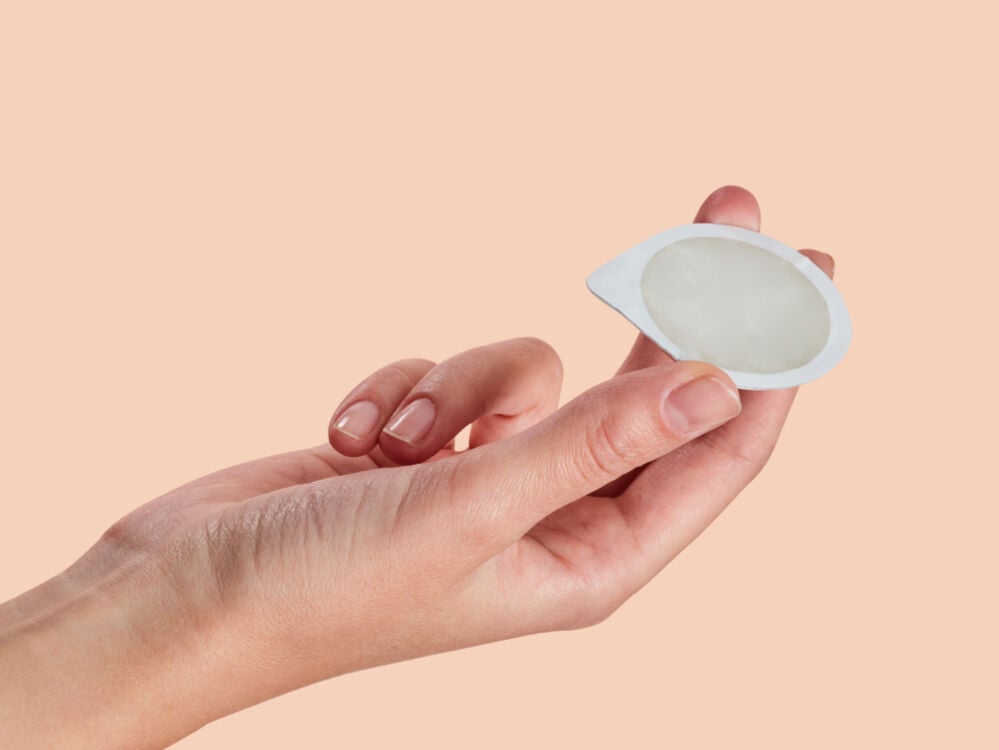 hand holding a condom hand holding a condom