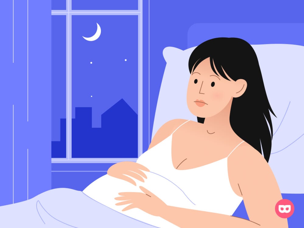 Pregnant woman awake at night in bed  Pregnant woman awake at night in bed