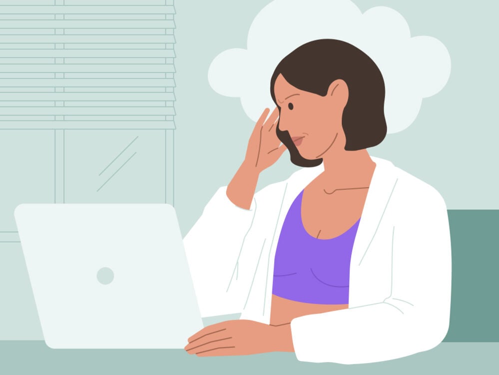Woman at laptop with brain fog Woman working with brain fog