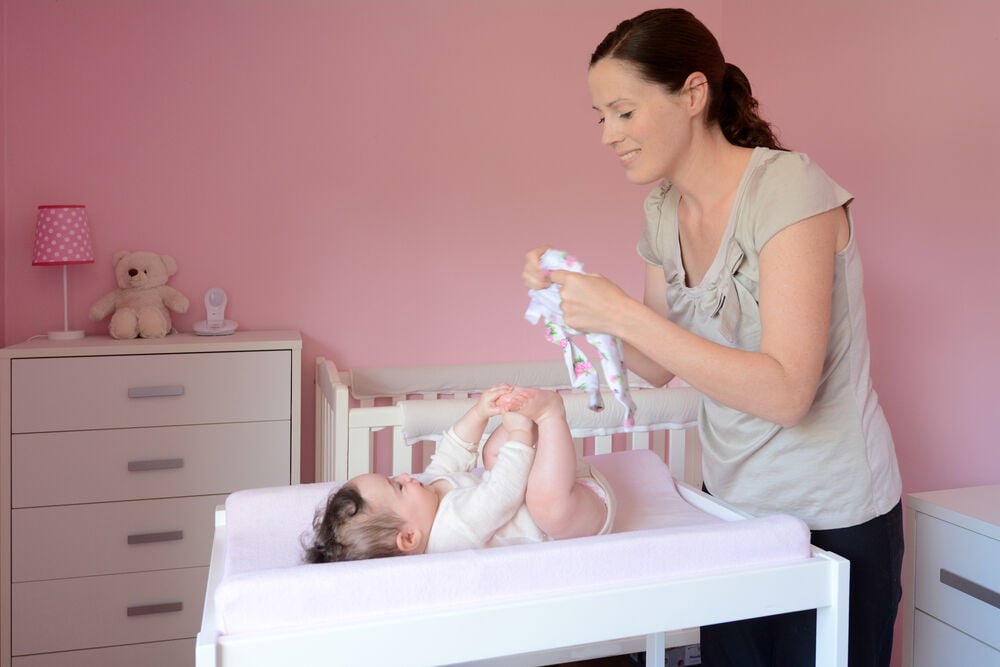 A mother dressing a baby for bedtime A mother dressing a baby for bedtime