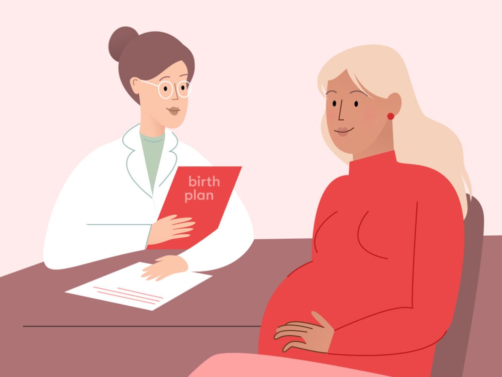 A pregnant woman in her third trimester at the doctor going through birth plan A pregnant woman in her third trimester at the doctor going through birth plan