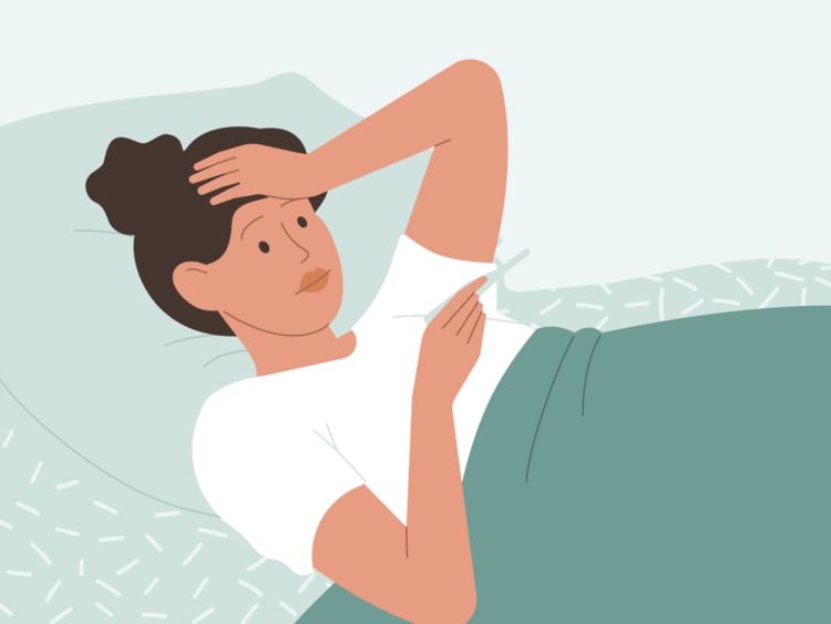 woman checking her basal body temperature woman in bed taking basal body temperature