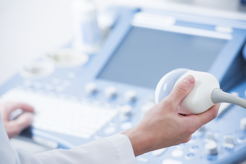 doctor's hands close up preparing for an ultrasound device scan doctor's hands close up preparing for an ultrasound device scan