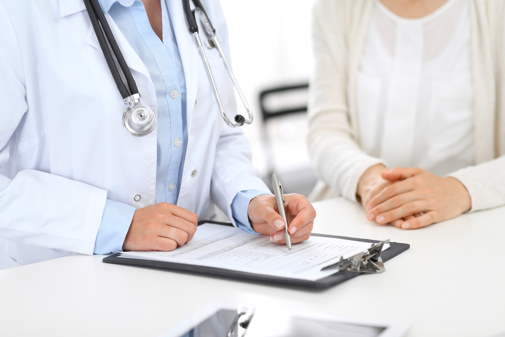 doctor and female patient discussing swollen lymph nodes doctor and female patient discussing swollen lymph nodes