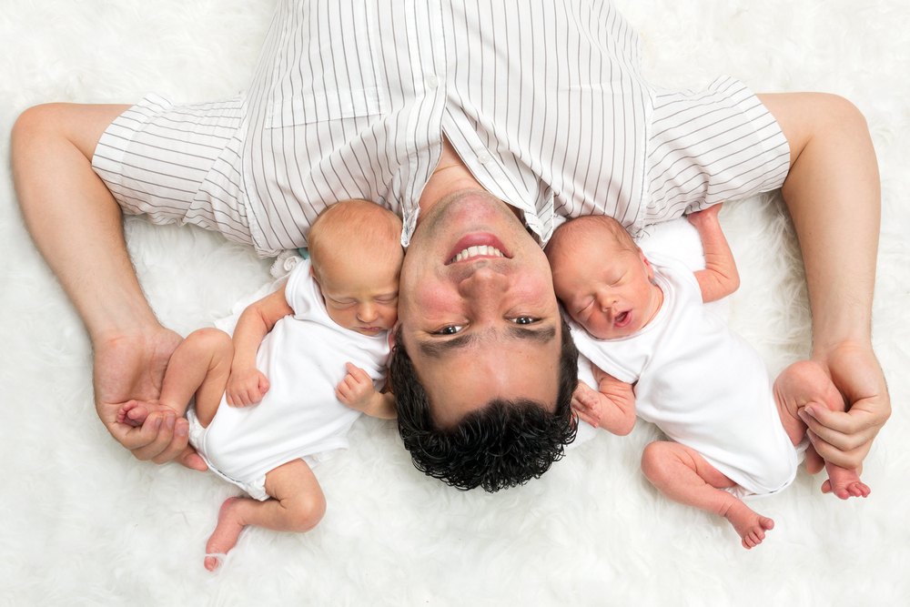happy father with his newborn twins happy father with his newborn twins