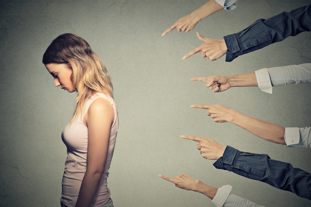 fingers pointing to the girl who feels guilty fingers pointing to the girl who feels guilty