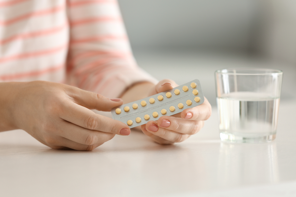A woman learning how to use birth control pills A woman learning how to use birth control pills