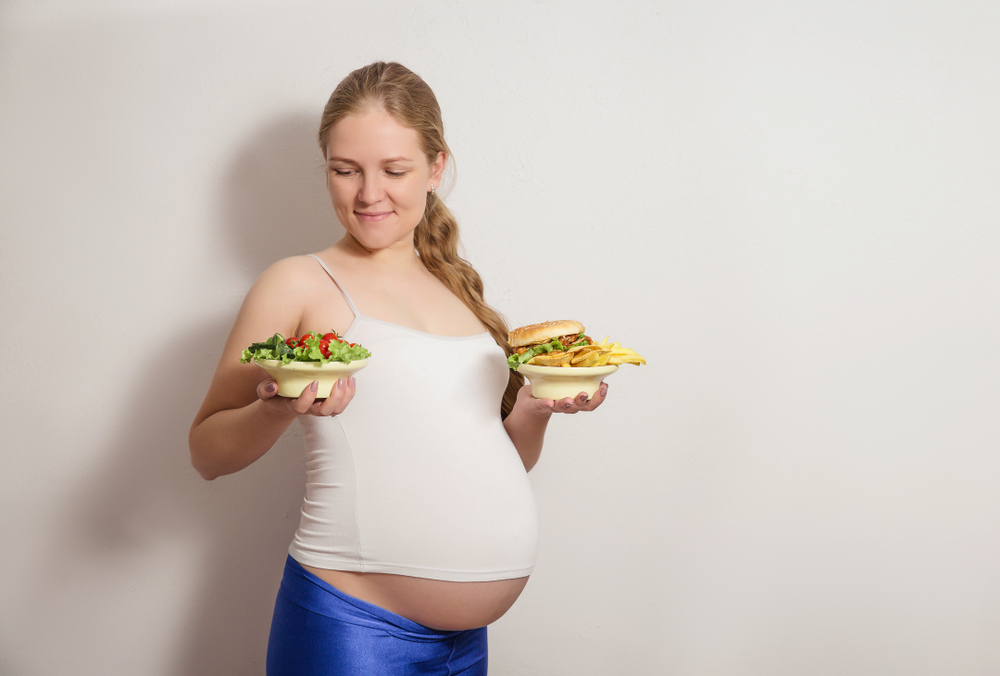 pregnant woman with two plates pregnant woman with two plates