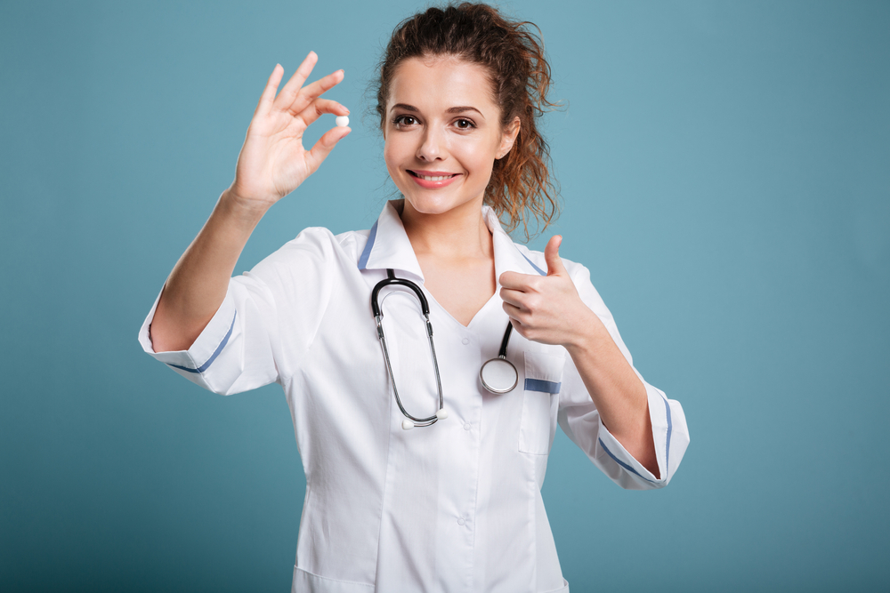 woman doctor holding a pill woman doctor holding a pill