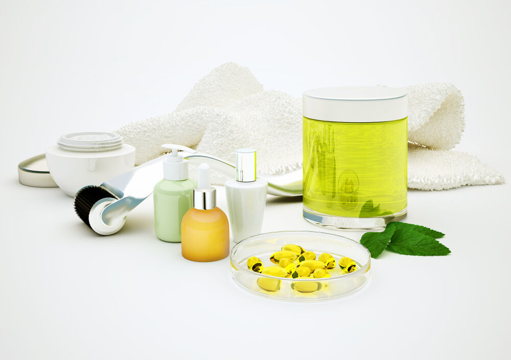 Serum, retinol, moisturizer, glass vial and derma roller for skincare