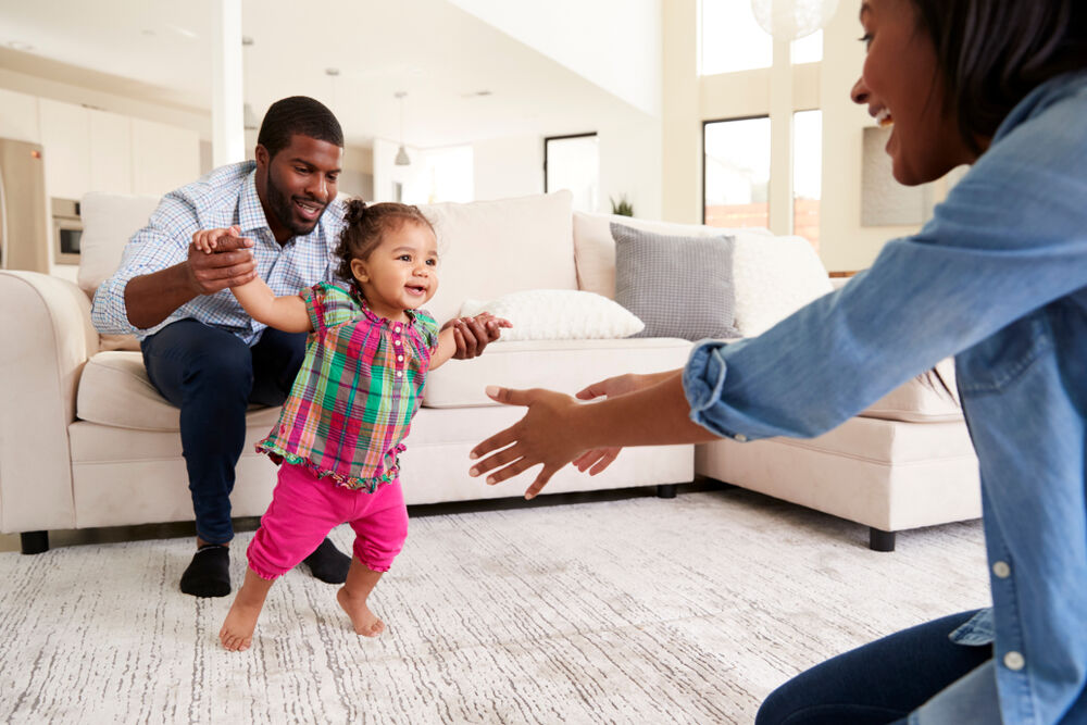 An 11-month-old baby attempting to walk 