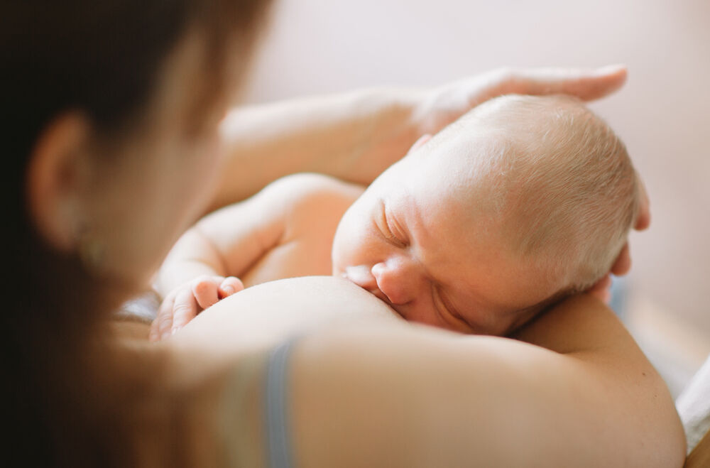 A breastfed baby having orange poop