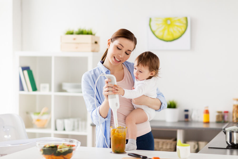 A mother preparing food for her 11-month-old-baby