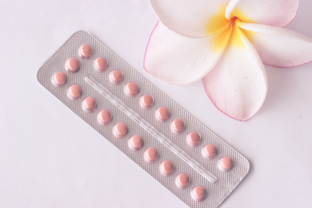 oral contraception pills and a flower