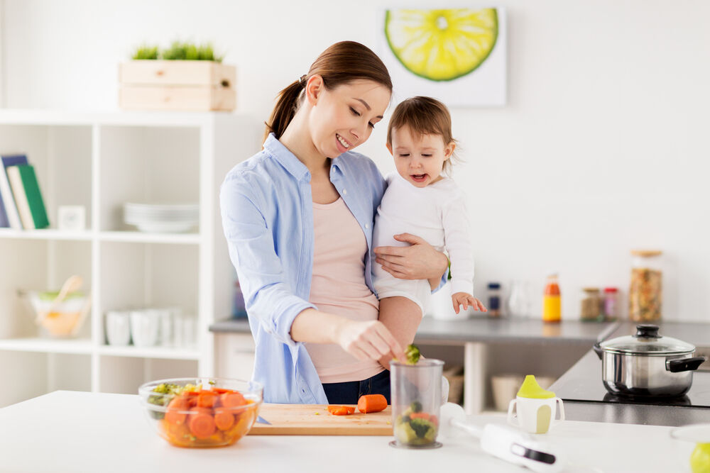 A mother preparing food for her 11-month-old baby