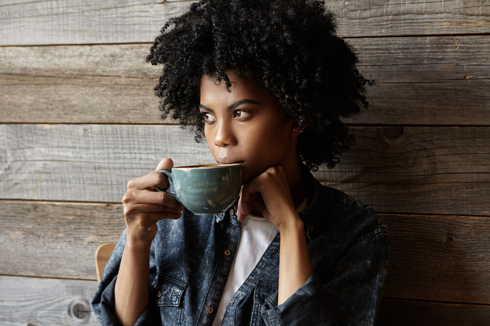 A woman having diverticulitis and drinking coffee