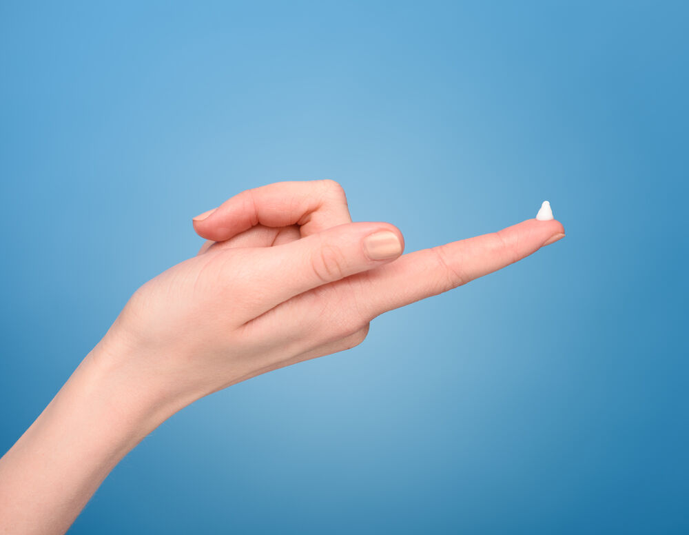 A woman applying progesterone cream