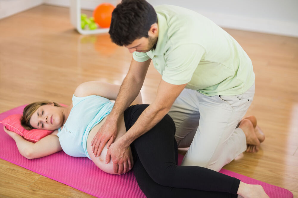 A chiropractor performs a technique for turning a breech baby