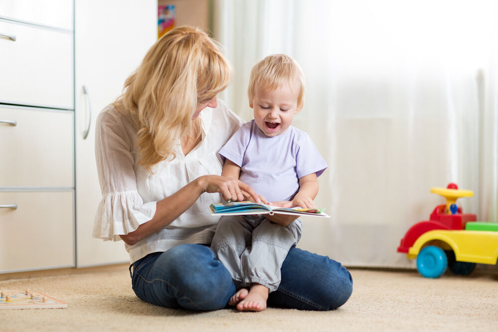 A woman reading to her baby