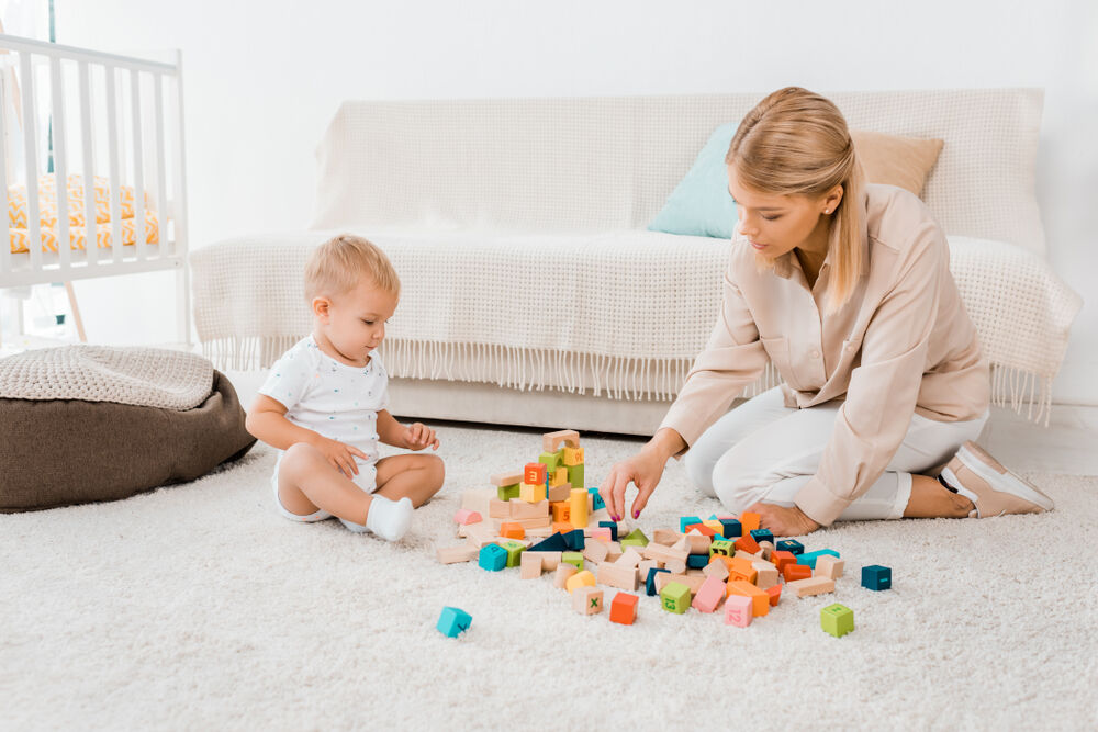 A baby playing with the best 9-month-old baby toys for physical development