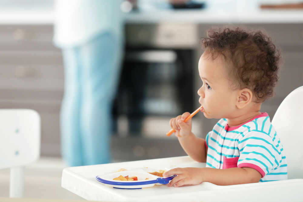 A baby eating 10-month-old baby food