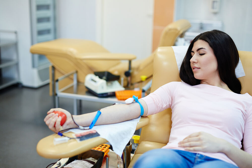 A woman donating blood with herpes