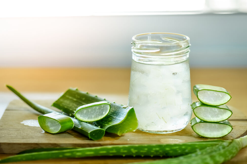 fresh aloe vera leaves and glass of aloe vera juice