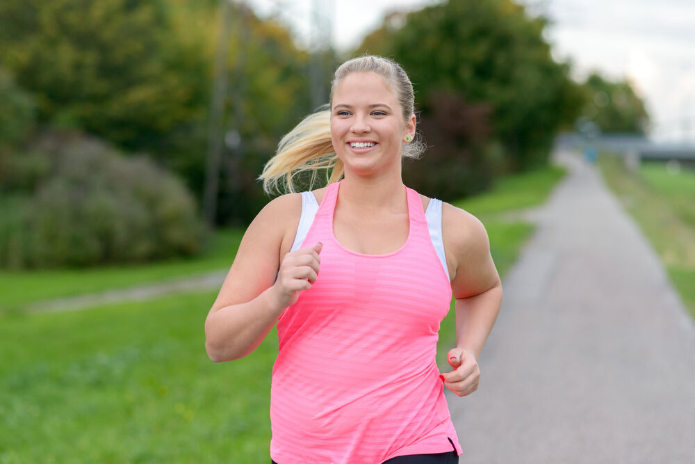 A body positive woman running on her periods