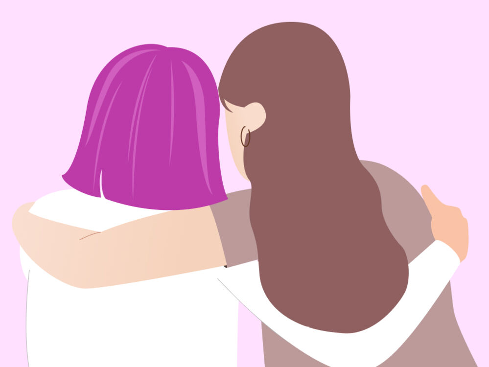 Two people with long and short hair hugging each other 