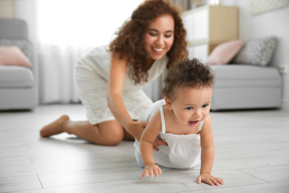 An eight-month-old baby crawling