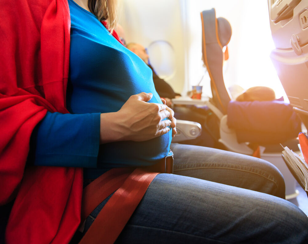A woman flying during the third trimester