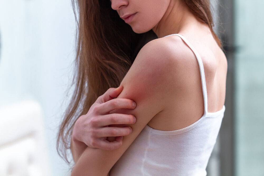 A woman having itchy skin with no rash