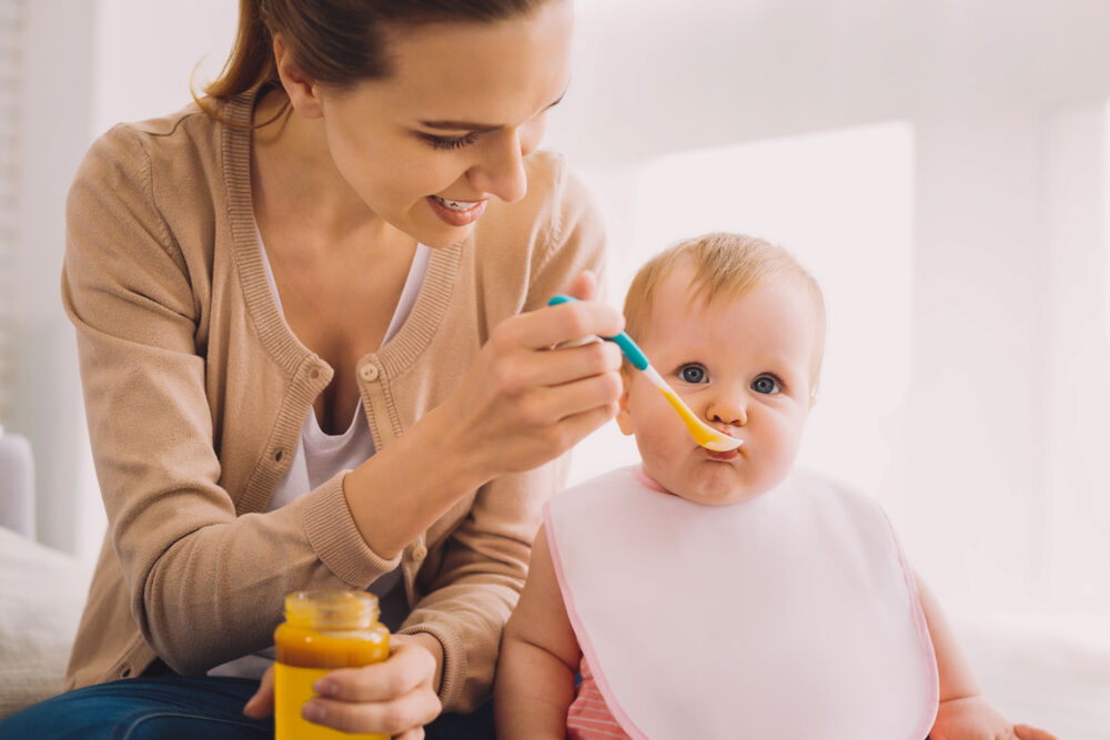 A baby having a good general 8-month-old feeding schedule